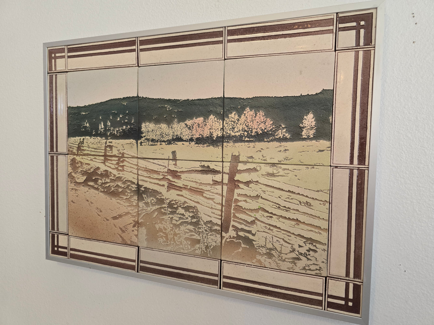 This is a view from the left to show the frame that the tiles are mounted in.

These tiles are handmade porcelain ceramic tiles that could be installed as kitchen wall tiles, kitchen backsplash tiles. 
This image is intended to remind us of our connection to nature.